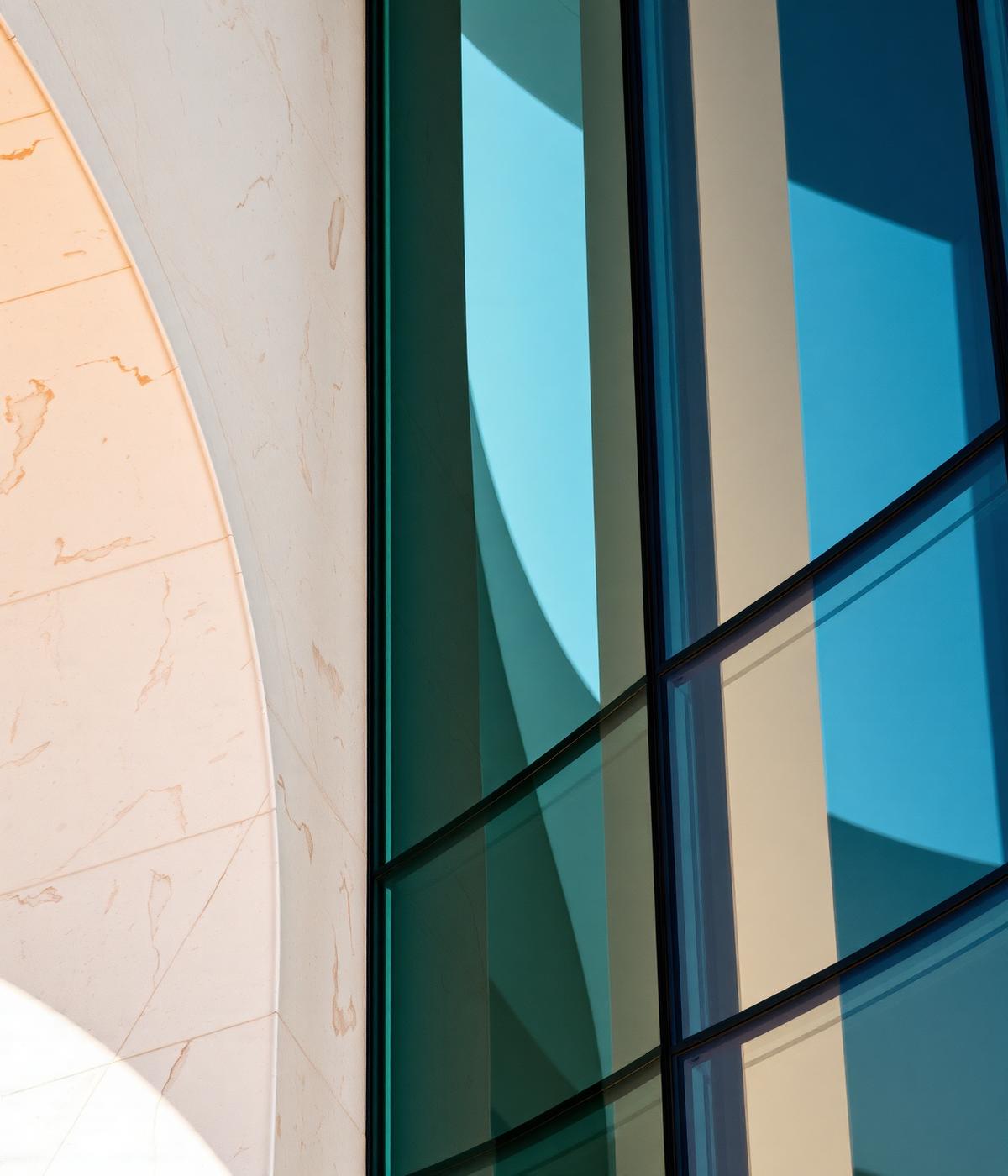 Curved travertine and glass facade detail